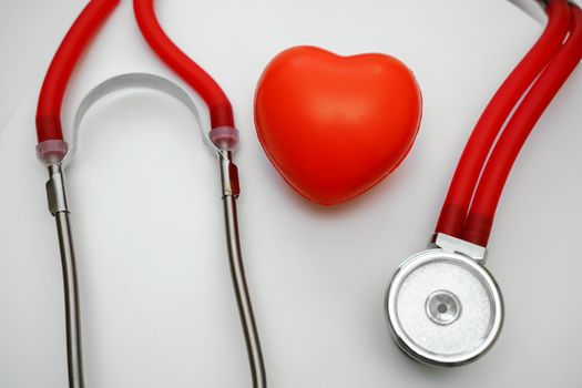 Stethoscope and red heart on white background, heart health, health insurance concept.