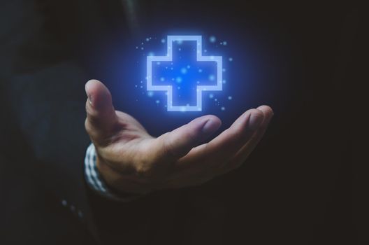 Man hand icon insurance cross. Health care medical symbols virtual screen. Business concept.