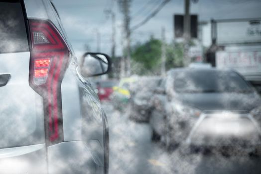 Car exhaust fumes during traffic jams on the road cause environmental emissions.