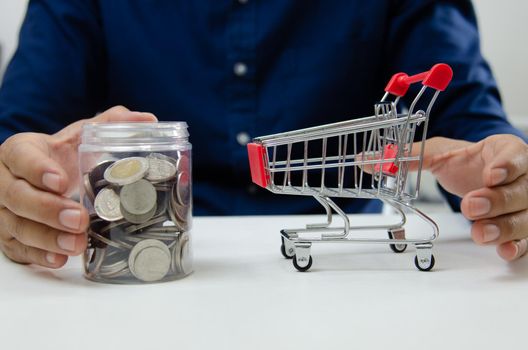 Business finance and investment economy shopping concept. Businessman money coin saving and jar.