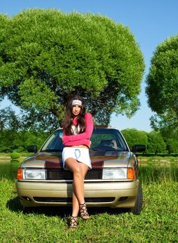 Beautiful girl ready for washing a retro car at summer - pinup style