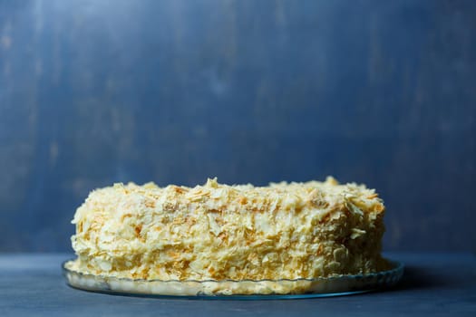 homemade Napoleon cake with cream on a gray background