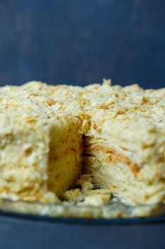 homemade Napoleon cake with cream on a gray background