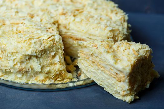 homemade Napoleon cake with cream on a gray background