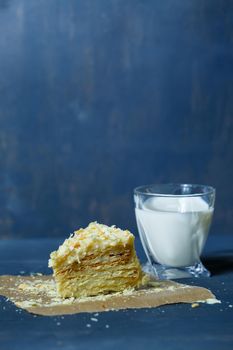 homemade Napoleon cake with cream on a gray background