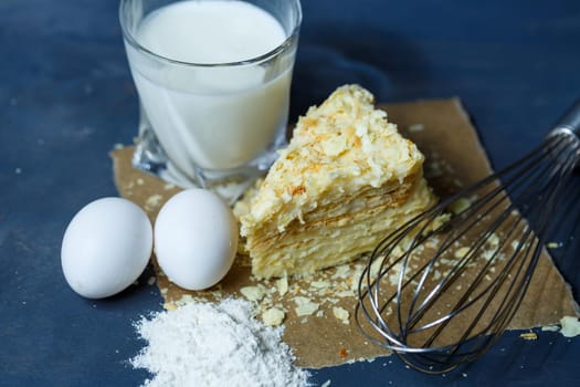 homemade Napoleon cake with cream on a gray background