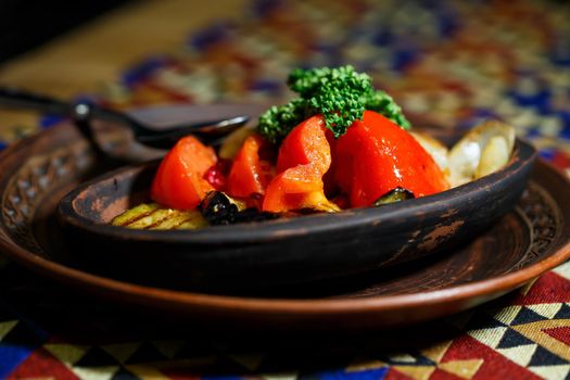 Grilled vegetables in a clay plate.