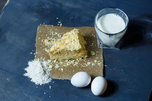 homemade Napoleon cake with cream on a gray background