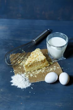 homemade Napoleon cake with cream on a gray background