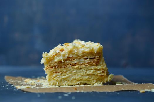 homemade Napoleon cake with cream on a gray background