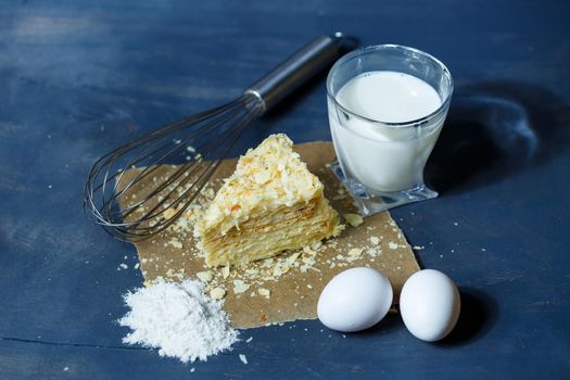 homemade Napoleon cake with cream on a gray background