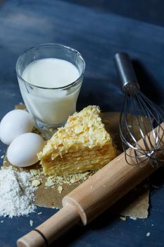 homemade Napoleon cake with cream on a gray background