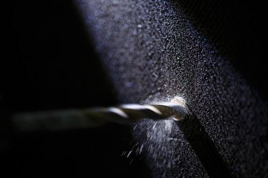 Drilling a wall with a concrete drill for a drill