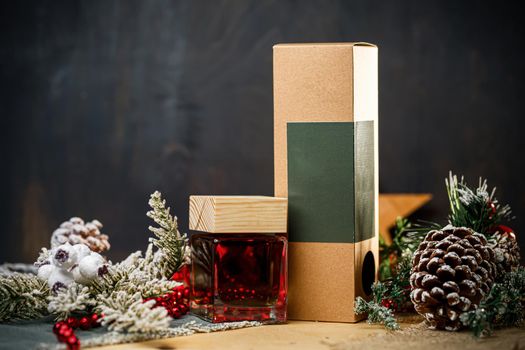 Perfume bottle New Year's gift. Stylish New Year decor perfume bottle is under the tree. Fashionable perfumes in New Year's locations. Perfumes for women