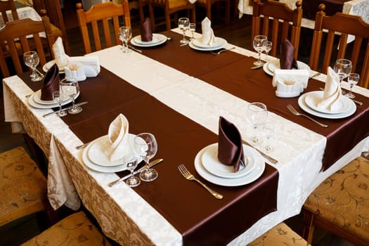 Table setting in a restaurant. Glass, plate, fork, knife