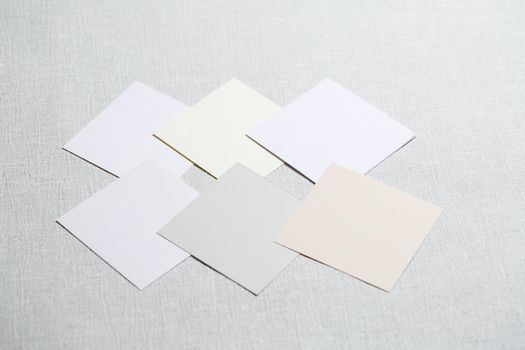 square pieces of multi-colored fabric laid out on a gray background