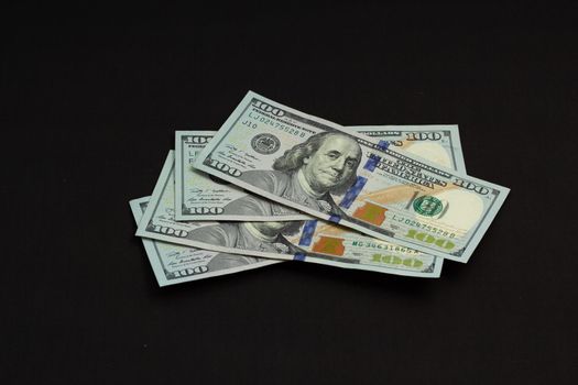 American cash money, banknotes four hundred us dollars on black background, one hundred dollar bills in stack