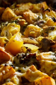 Baked potatoes with mushrooms and cheese with seasonings and herbs