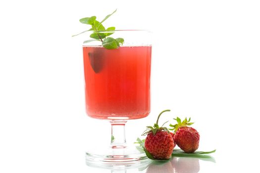 Cold summer strawberry kvass with mint in a glass isolated on white background