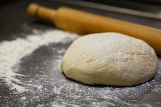 flour dough for baking cookies on the kitchen table