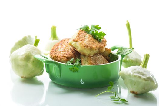 vegetable fried squash and zucchini cutlets in a ceramic form isolated on a white background