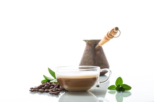 Cup of coffee latte with heart shape and coffee beans isolated on white background