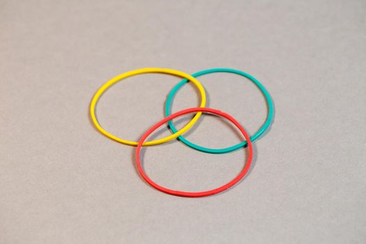 Colored rubber bands for money on a colored background. Stationery accessories
