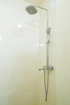 Bright bathroom with shower, shower head, light tile