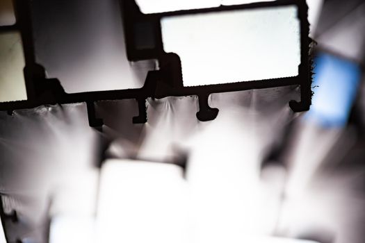 Steel factory warehouse displayed aluminum profile for window, door, bathroom box with blurry background, used as a background or texture, soft focus