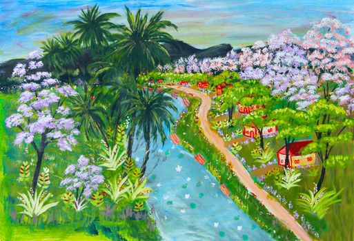 Small rural village huts and homes along a flowing river in a tropical country with coconut trees and flowering trees in full bloom