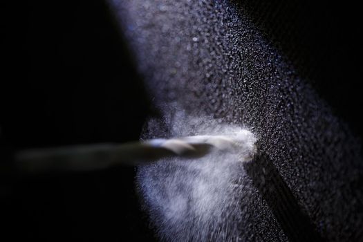 Drilling a wall with a concrete drill for a drill