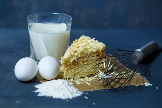 homemade Napoleon cake with cream on a gray background