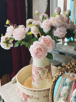 The pink roses in a vintage vase. Boudoir style.