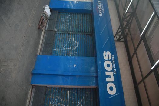 salvador, bahia, brazil - august 6, 2022: homeless man sleeping in front of a collection store in the city of Salvador.