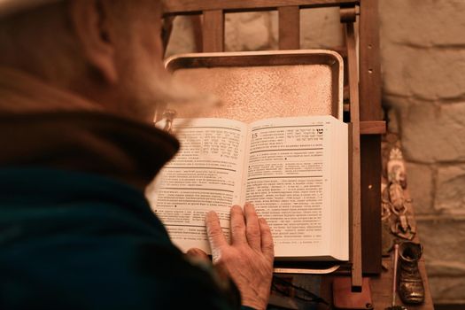 Believing Jew reads torah and prays