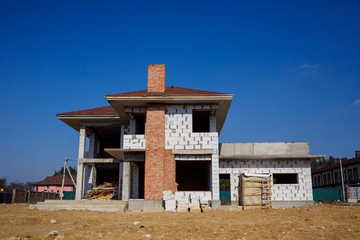construction of a country two-story house from a gas block