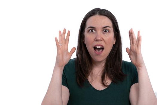 close-up of young girl with hands raised in surprise gesture, isolated on white background