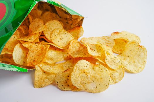 Potato chips in open bag, delicious BBQ seasoning spicy for crips, thin slice deep fried snack fast food in open bag.