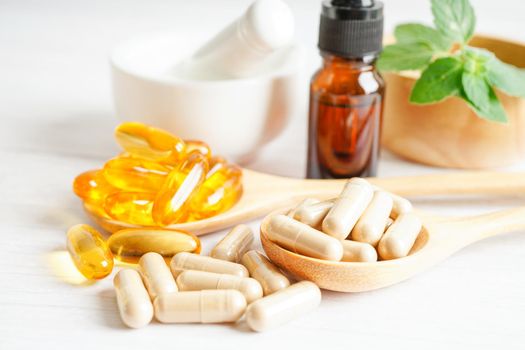 Alternative medicine herbal organic capsule with vitamin E omega 3 fish oil, mineral, drug with herbs leaf natural supplements for healthy good life.