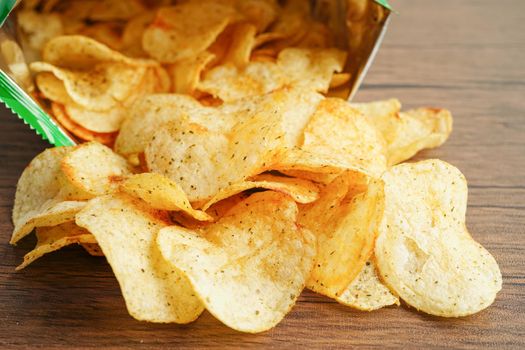 Potato chips in open bag, delicious BBQ seasoning spicy for crips, thin slice deep fried snack fast food in open bag.