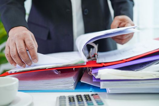 Businessman working and prepare paperwork report data to analysis information in file binder at office.