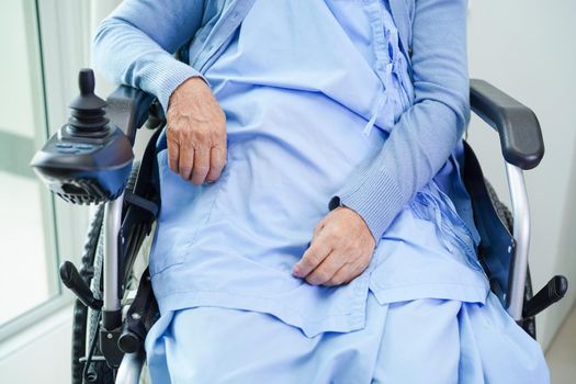 Asian elderly woman disability patient walk with walker in nursing hospital, medical concept.