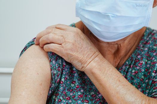 Asian elder senior woman getting vaccine for protect corona virus.