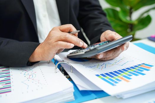 Business woman working and analysis with statistic graph in office. 