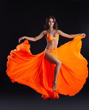 beauty young woman dance in orange veil arabic style costume