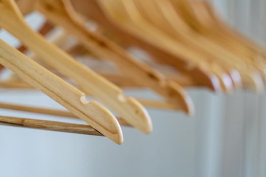 Close-up of wardrobe with wooden clothes hanger