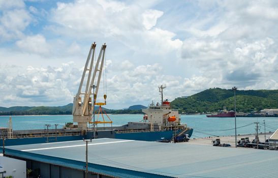 Industrial port crane lift up loading export containers box onboard at port of Thailand.