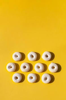 french and spanish speciality rousquilles on the yellow background, pattern, hard light, top view, copy space