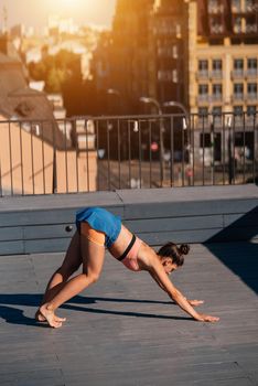 Young woman practicing yoga on the roof