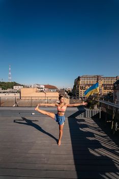Young woman practicing yoga on the roof